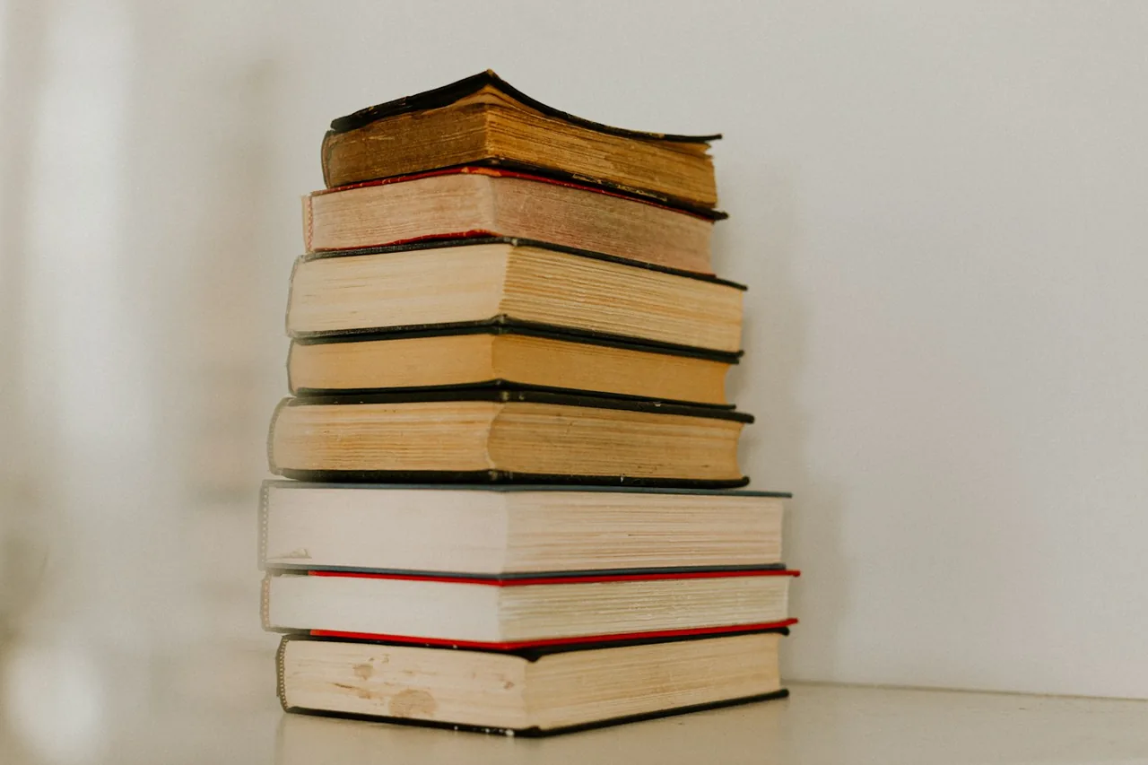 A stack of books on a light surface.