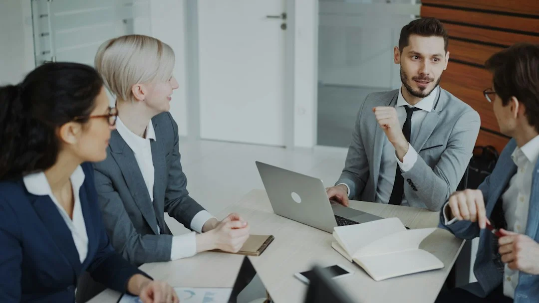 Professionals discussing work in an office.