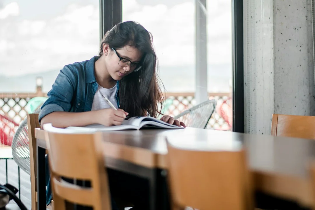 A learner concentrating on written study material.
