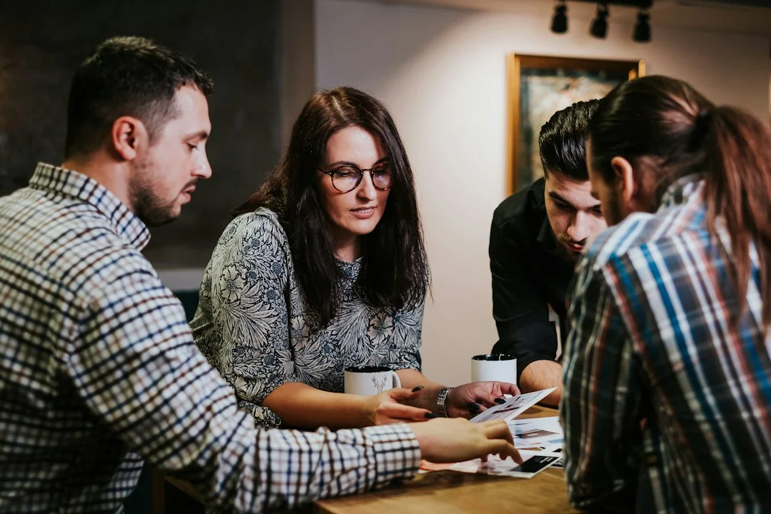 A group reviewing documents around a table.