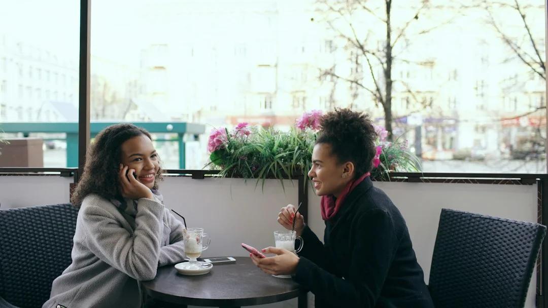 Two people talking together in a cafe.
